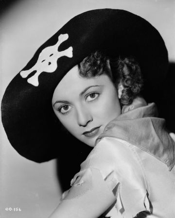British-American actress Olivia de Havilland wears a black hat with a stylized skull and crossbones, in 1935. This is the year the Tokyo-born 19-year-old starred alongside Errol Flynn in pirate adventure film "Captain Blood." 