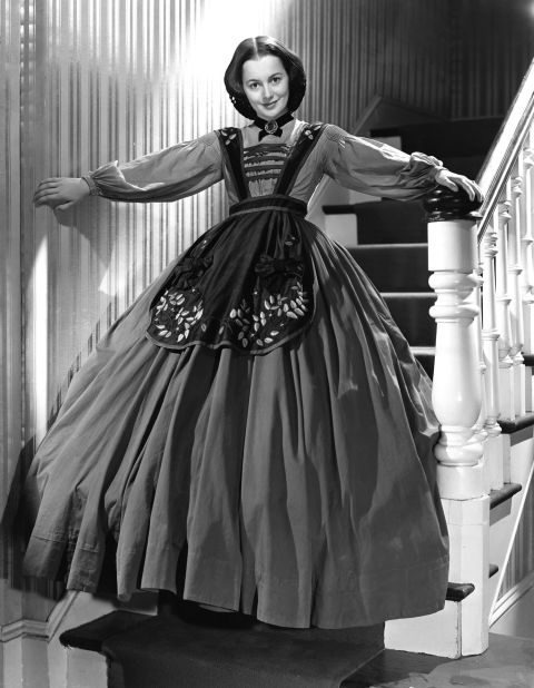 De Havilland shows off her Civil War period costume on the set of epic "Gone with the Wind," which was released in 1939. 
