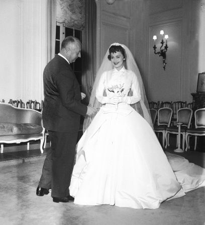 De Havilland wears a custom Christian Dior wedding dress for the film "The Ambassador's Daughter," which was shot in Paris (1955).