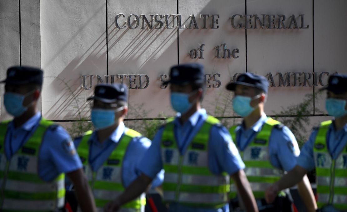 Policemen march in front of the US consulate in Chengdu, southwestern China's Sichuan province, on July 26.