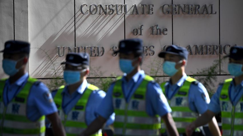 Policemen march in front of the US consulate in Chengdu, southwestern China's Sichuan province, on July 26, 2020. - The Chengdu mission was ordered shut in retaliation for the forced closure of Beijing's consulate in Houston, Texas, with both sides alleging the other had endangered national security. (Photo by Noel Celis / AFP) (Photo by NOEL CELIS/AFP via Getty Images)