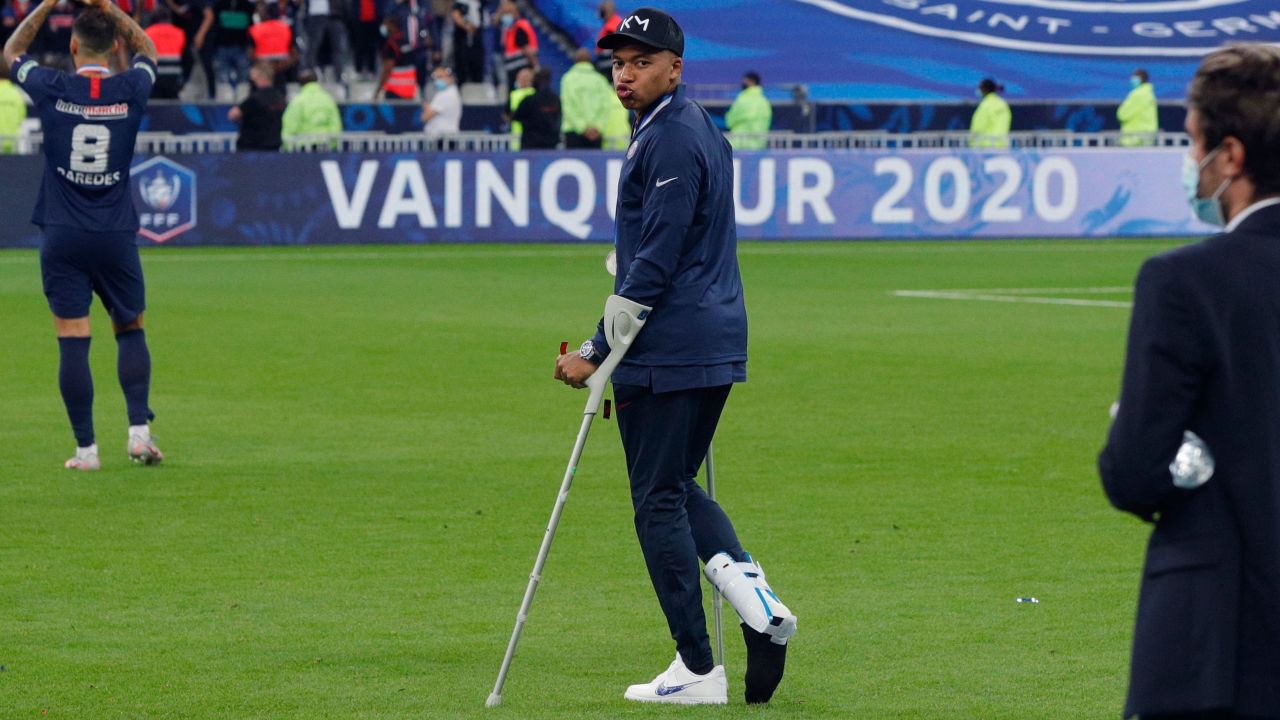 Paris Saint-Germain forward Kylian Mbappe walks with crutches after winning the French Cup final.