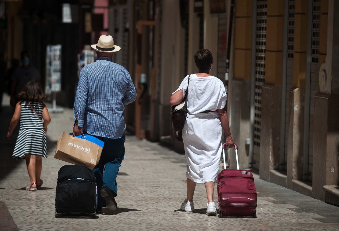 Tourists pictured in Malaga, Spain, as Covid-19 cases spike in the country, leading the UK and Norway to reintroduce mandatory quarantine for returning travelers. 