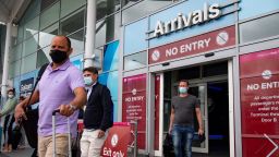Passengers arrive at Birmingham Airport from Malaga on Sunday, July 26, after the announcement on Saturday that travelers who had not returned from Spain by midnight would be forced to quarantine for 14 days.