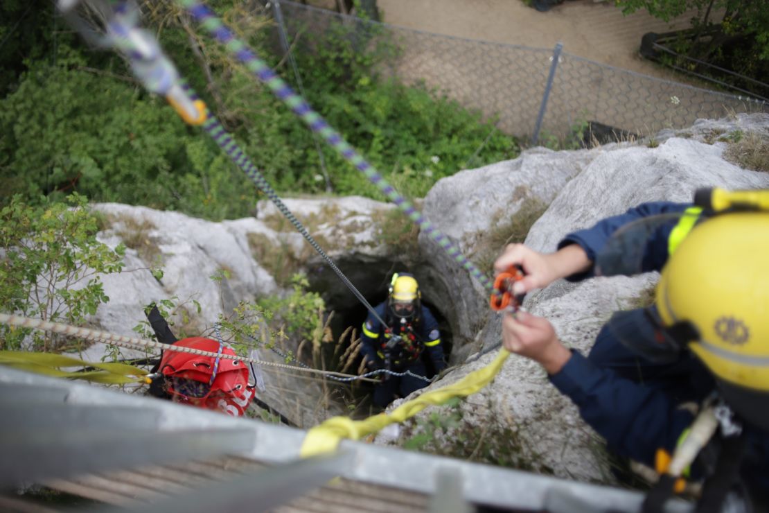 The rescuer wore breathing apparatus to go down the 130-foot well.