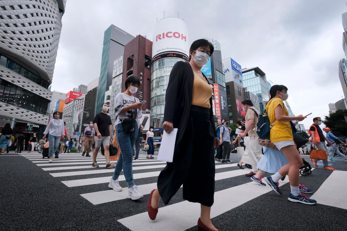 Pedestrians walk at a crossing in Tokyo's shopping district of Ginza on July 25, 2020.