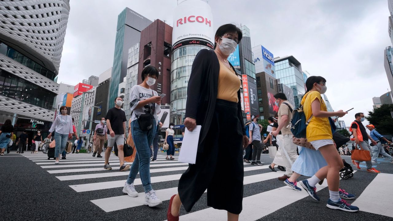 Pedestrians walk at a crossing in Tokyo's shopping district of Ginza on July 25, 2020. 
