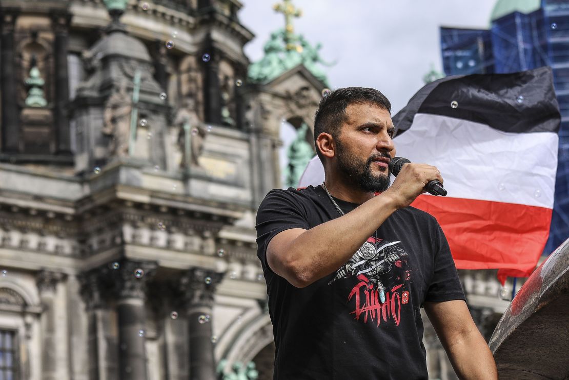 German vegan chef Attila Hildmann, speaks to followers during an anti-restrictions protest in Berlin's Lustgarten park on 11 July 2020.