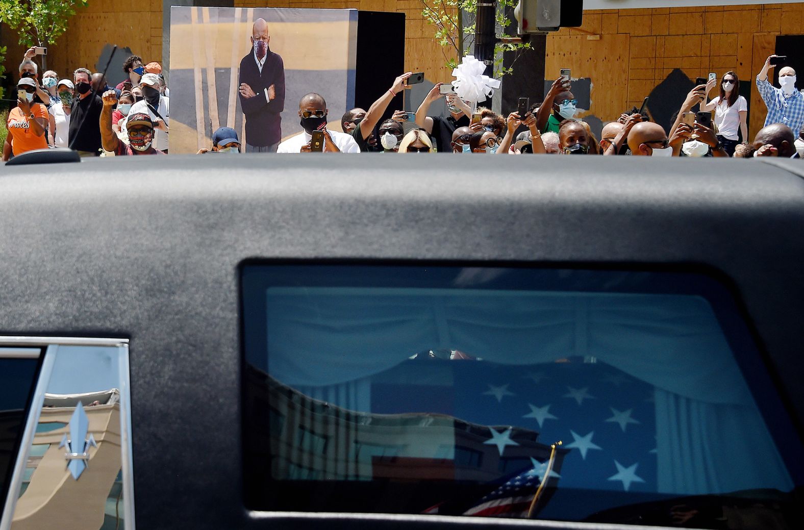 People gather at Black Lives Matter Plaza to watch Lewis' funeral procession.