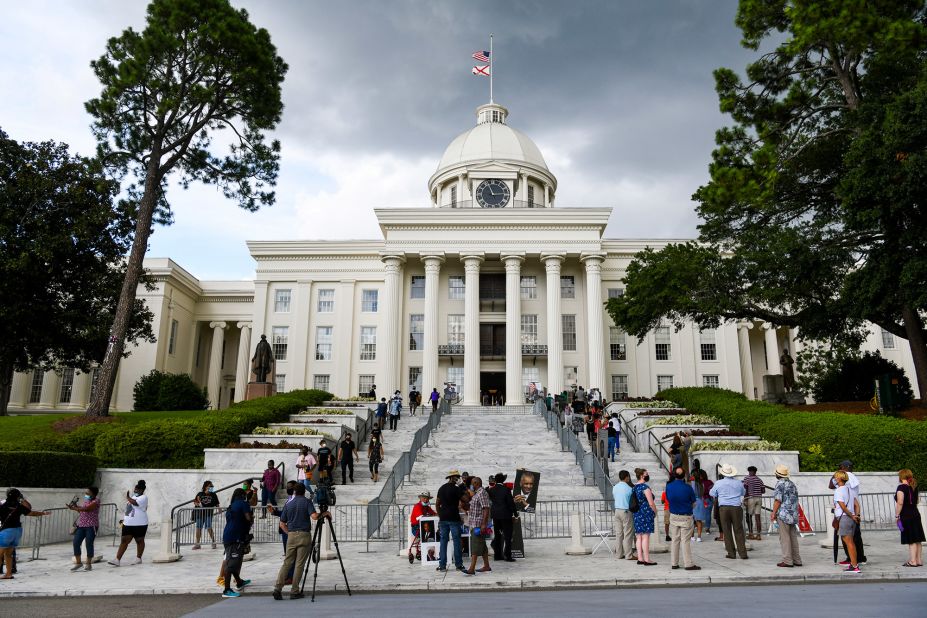 People in Montgomery, Alabama, wait in line to view Lewis' body at the state Capitol on Sunday.