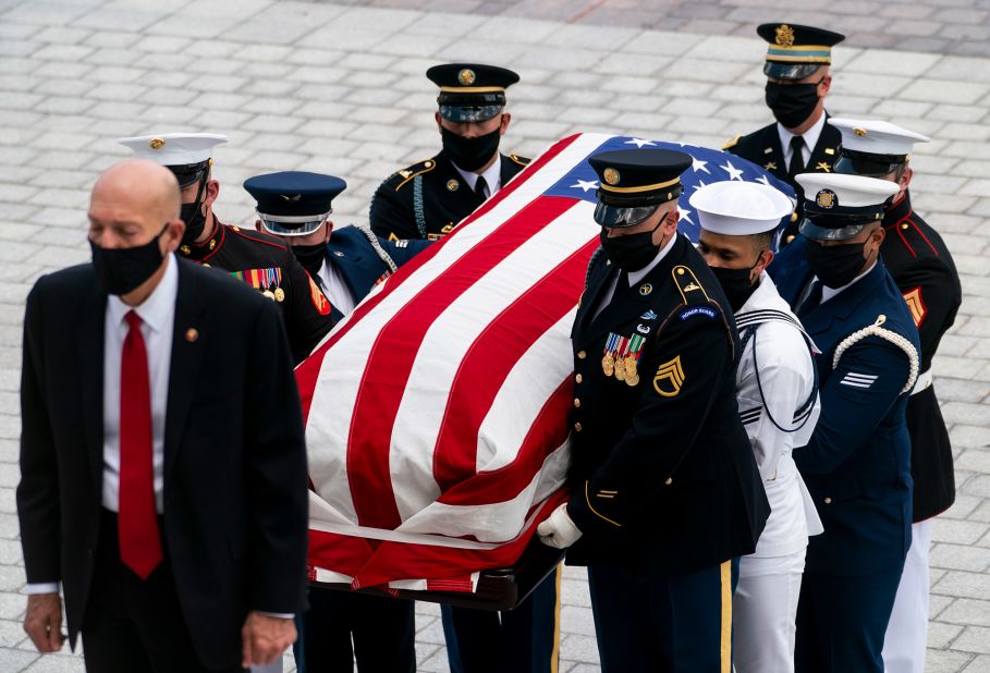 Lewis' flag-draped casket is carried to the Capitol.