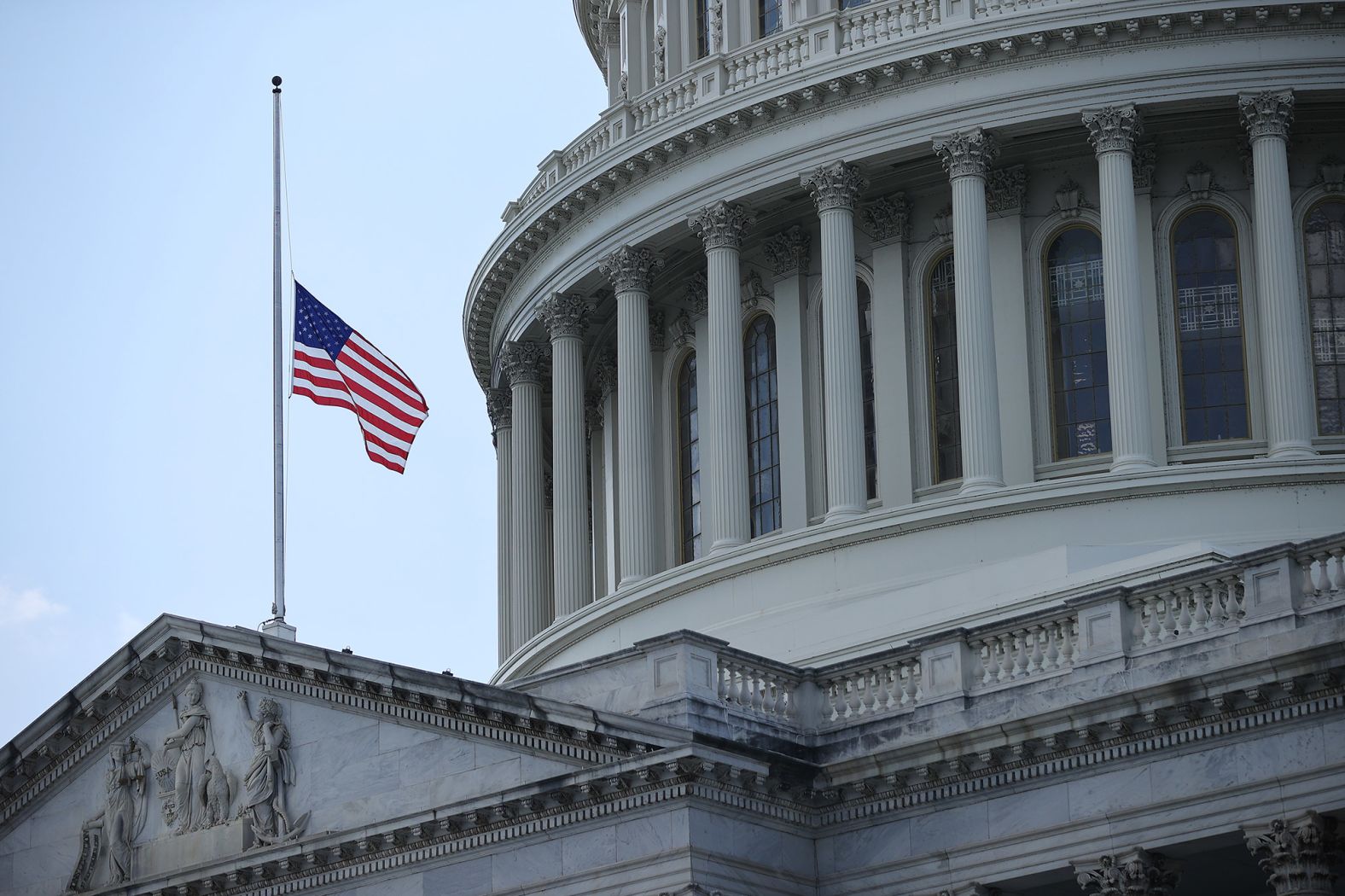 The American flag flies at half-staff outside the Capitol.