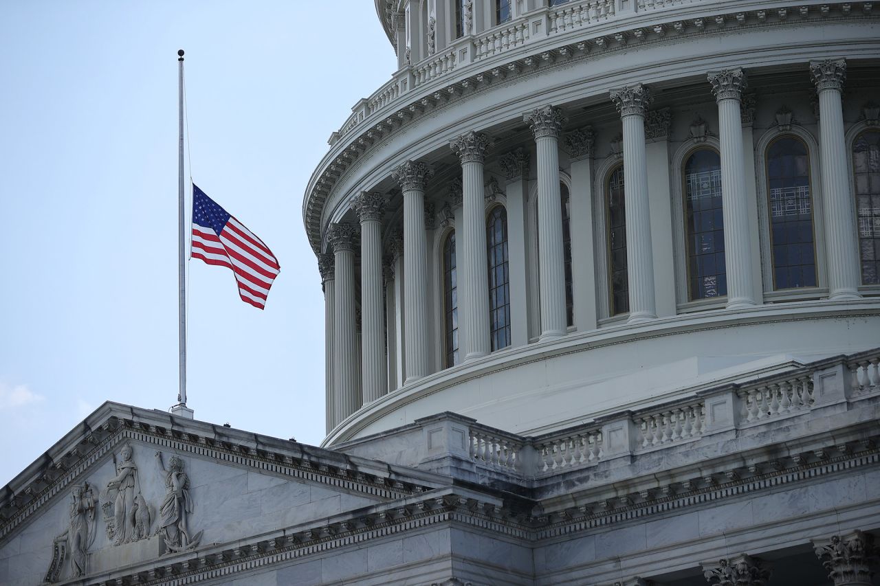 The American flag flies at half-staff outside the Capitol.