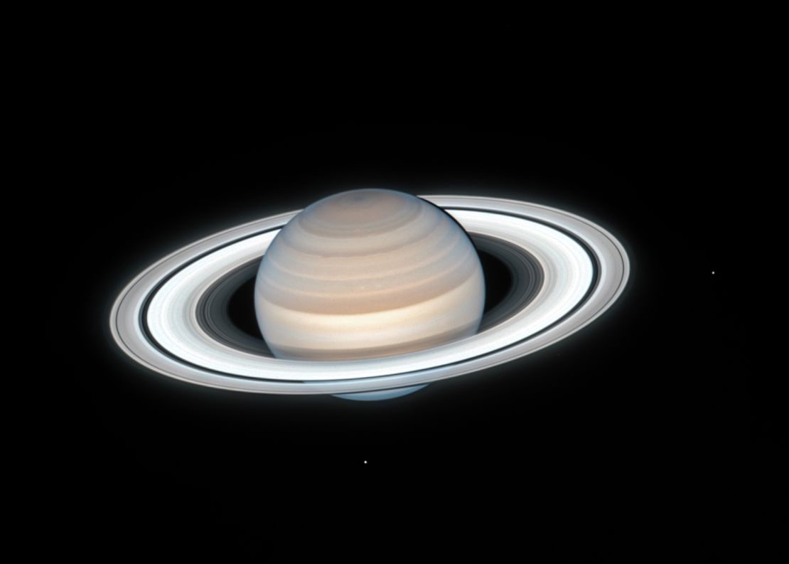 NASA's Hubble Space Telescope captured this image of Saturn on July 4, 2020. Two of Saturn's icy moons are clearly visible in this exposure. 