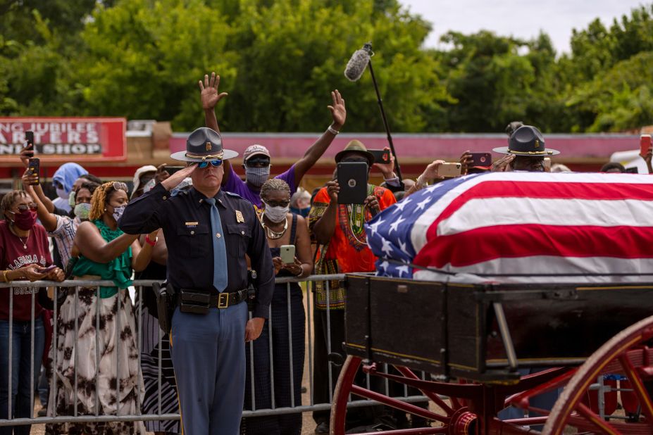 An Alabama state trooper salutes Lewis' casket in Selma.
