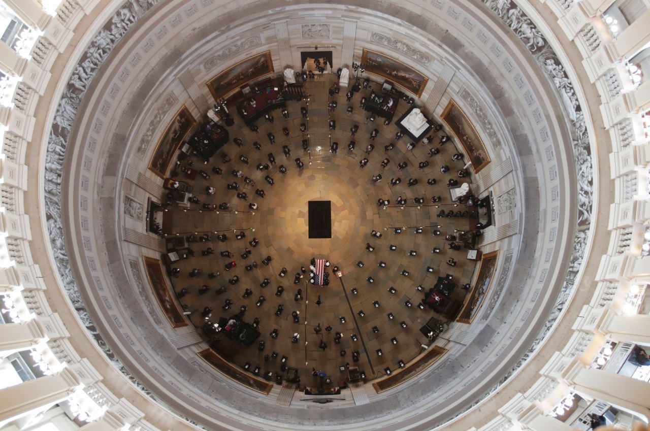 A military honor guard carries Lewis' casket in the US Capitol rotunda.