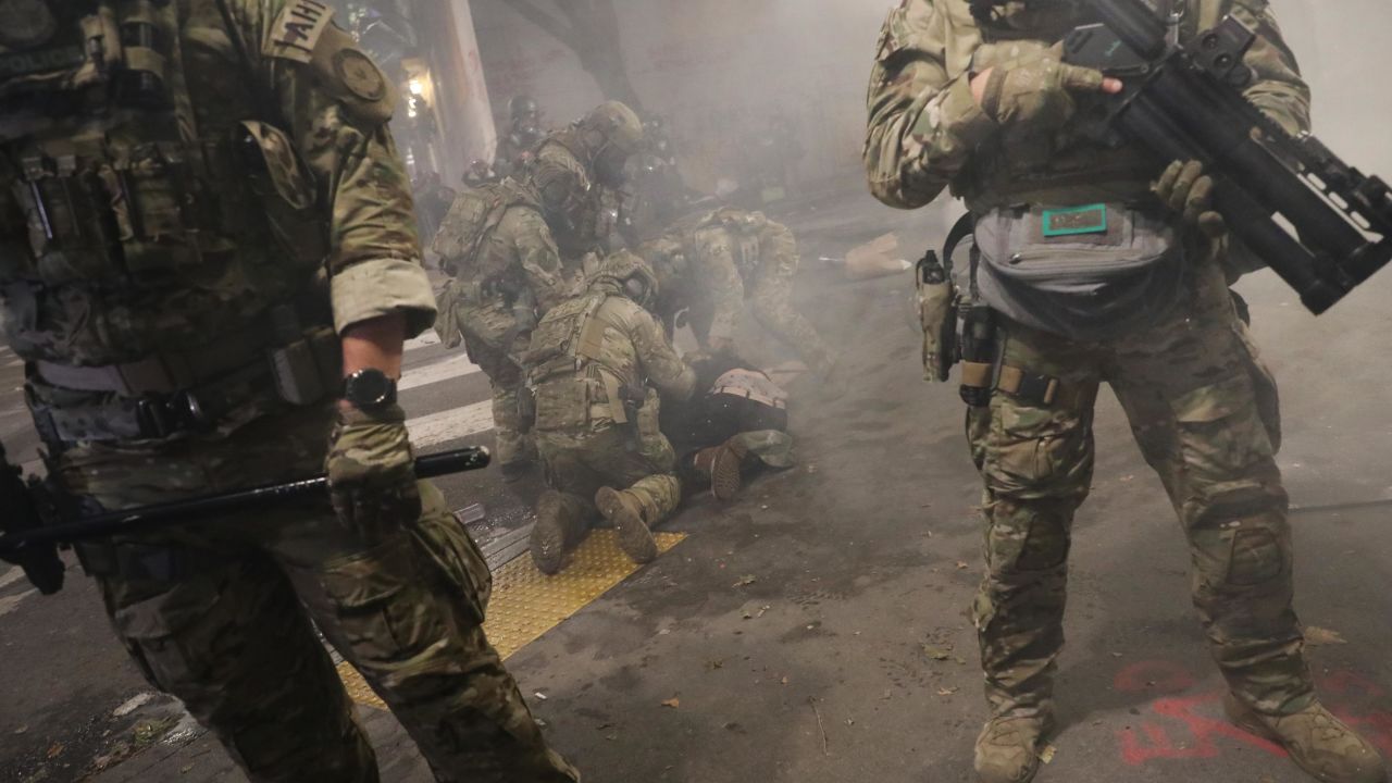 PORTLAND, OREGON - JULY 25: Federal Police arrest protesters in front of the Mark O. Hatfield federal courthouse in downtown Portland as the city experiences another night of unrest on July 25, 2020 in Portland, Oregon. For over 55 straight nights, protesters in downtown Portland have faced off in often violent clashes with the Portland Police Bureau and, more recently, federal officers. The demonstrations began to honor the life of George Floyd and other black Americans killed by law enforcement and have intensified as the Trump administration called in the federal officers. (Photo by Spencer Platt/Getty Images)