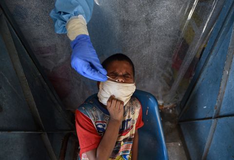 A health worker tests a child for Covid-19 at a school in New Delhi on July 27.