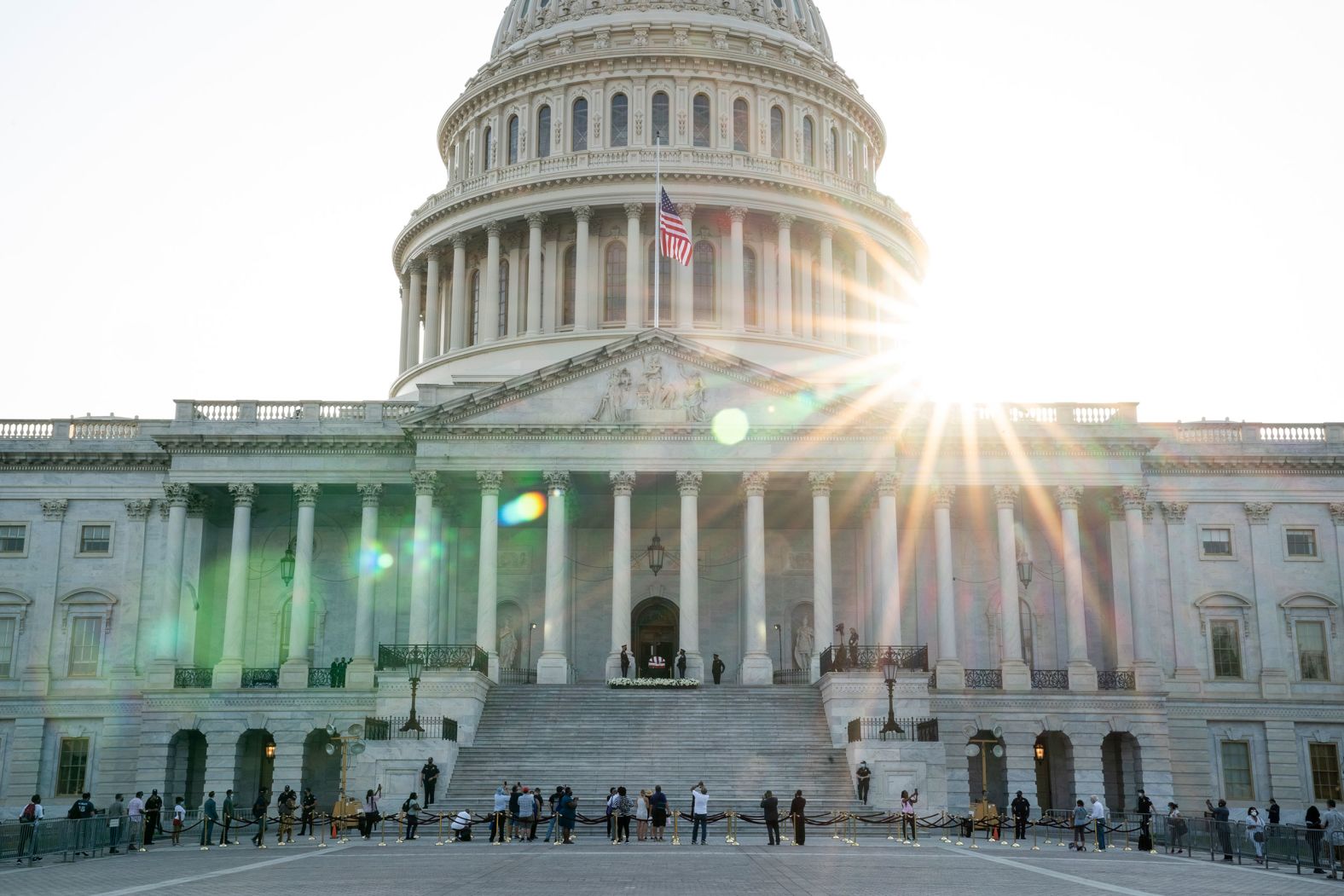 People wait in line at the base of the Capitol on Monday.