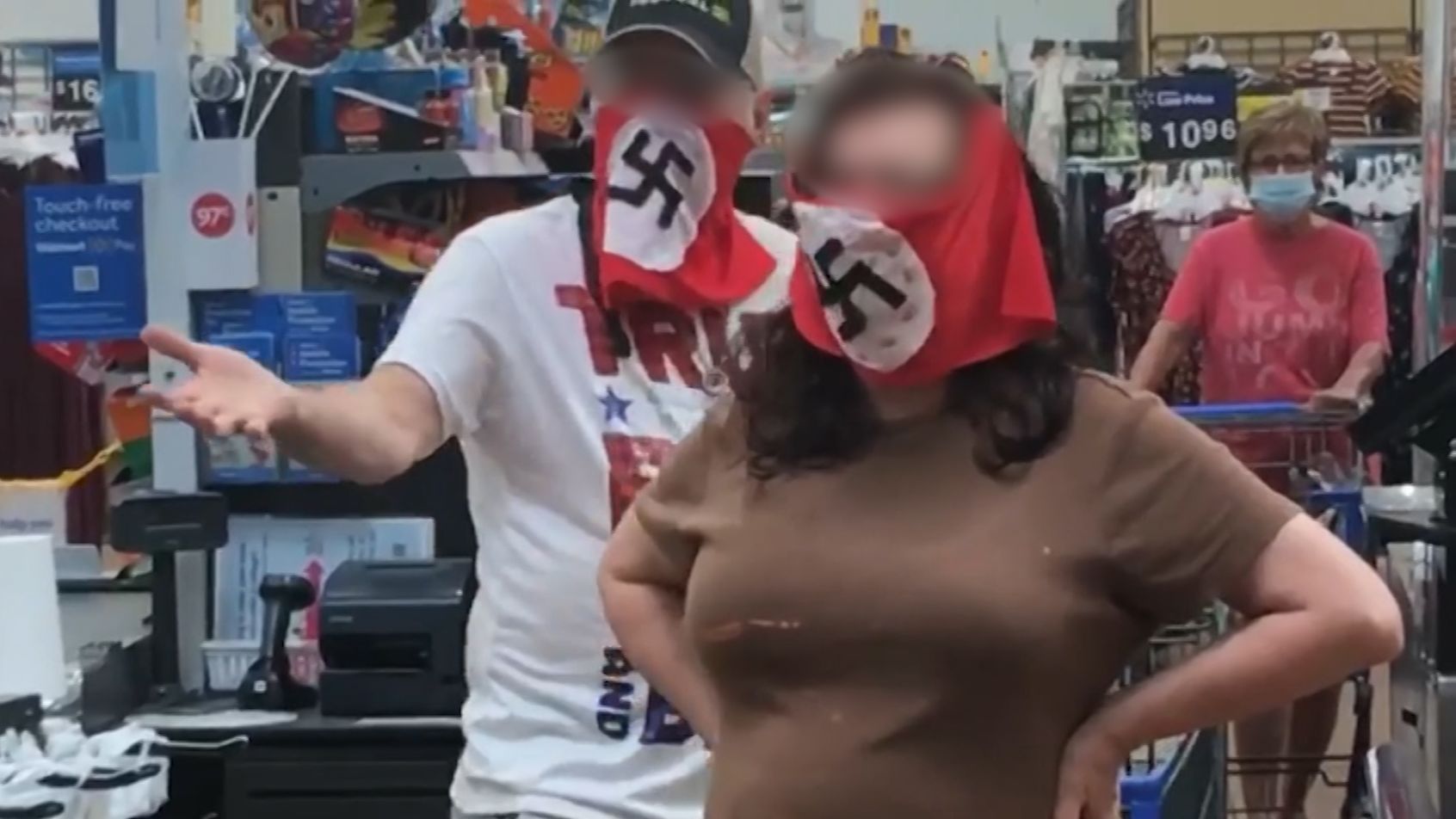 A couple has been banned from a Walmart after wearing swastika masks.