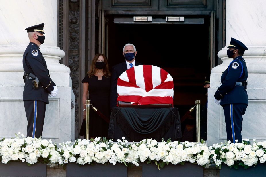 Vice President Mike Pence and his wife, Karen, visit Lewis' casket on the steps of the Capitol on Monday.