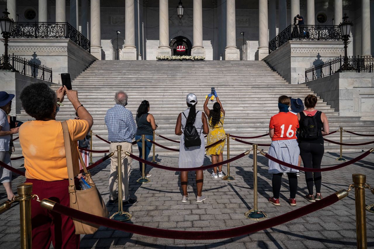 People view Lewis' casket on the US Capitol steps Tuesday. The public viewing took place outside because of the coronavirus pandemic.