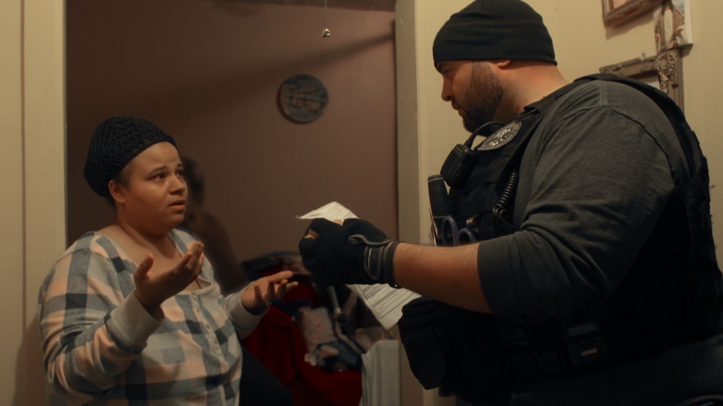 An ICE agent (right) exercises a warrant in Netflix's 'Immigration Nation.'