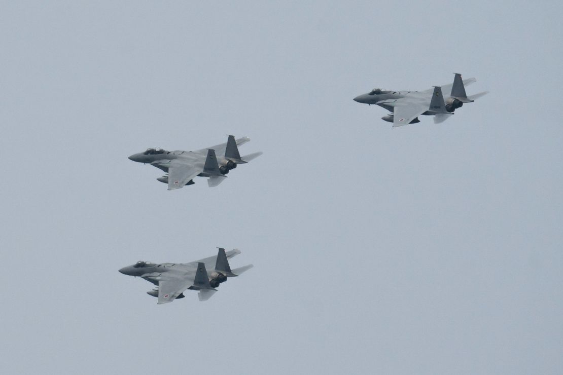 Japan's Air Self-Defense Force's F-15 fighter jets, one of the country's key defenses, fly during a review after the graduation ceremony of the National Defense Academy on March 22, 2020.