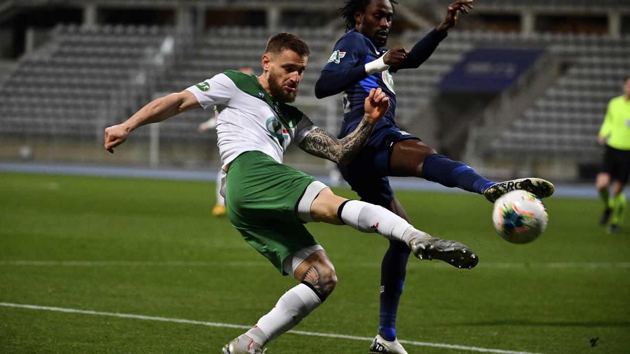 Saint-Etienne defender Mathieu Debuchy (left) fights for the ball with Paris FC's Jonathan Pitroipa in a French Cup match earlier this year.