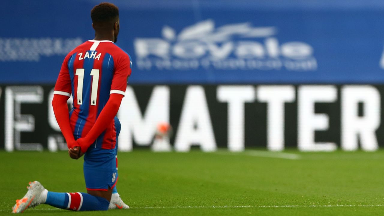 Wilfried Zaha takes a knee in support of the Black Lives Matter movement before the matcha against Burnley.