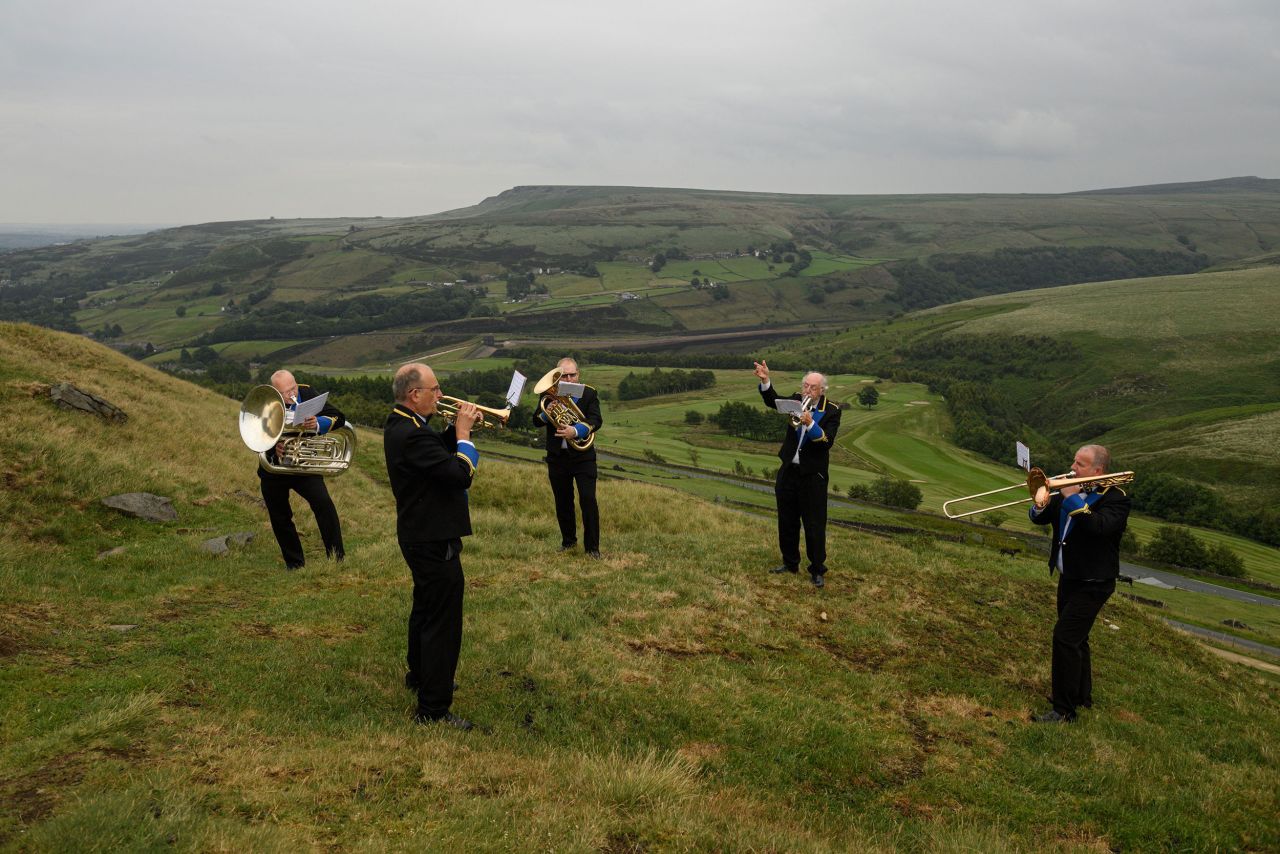 Members of the Meltham and Meltham Mills Band practice above the English village of Marsden on June 30. It was their first time practicing together since a government-imposed lockdown.