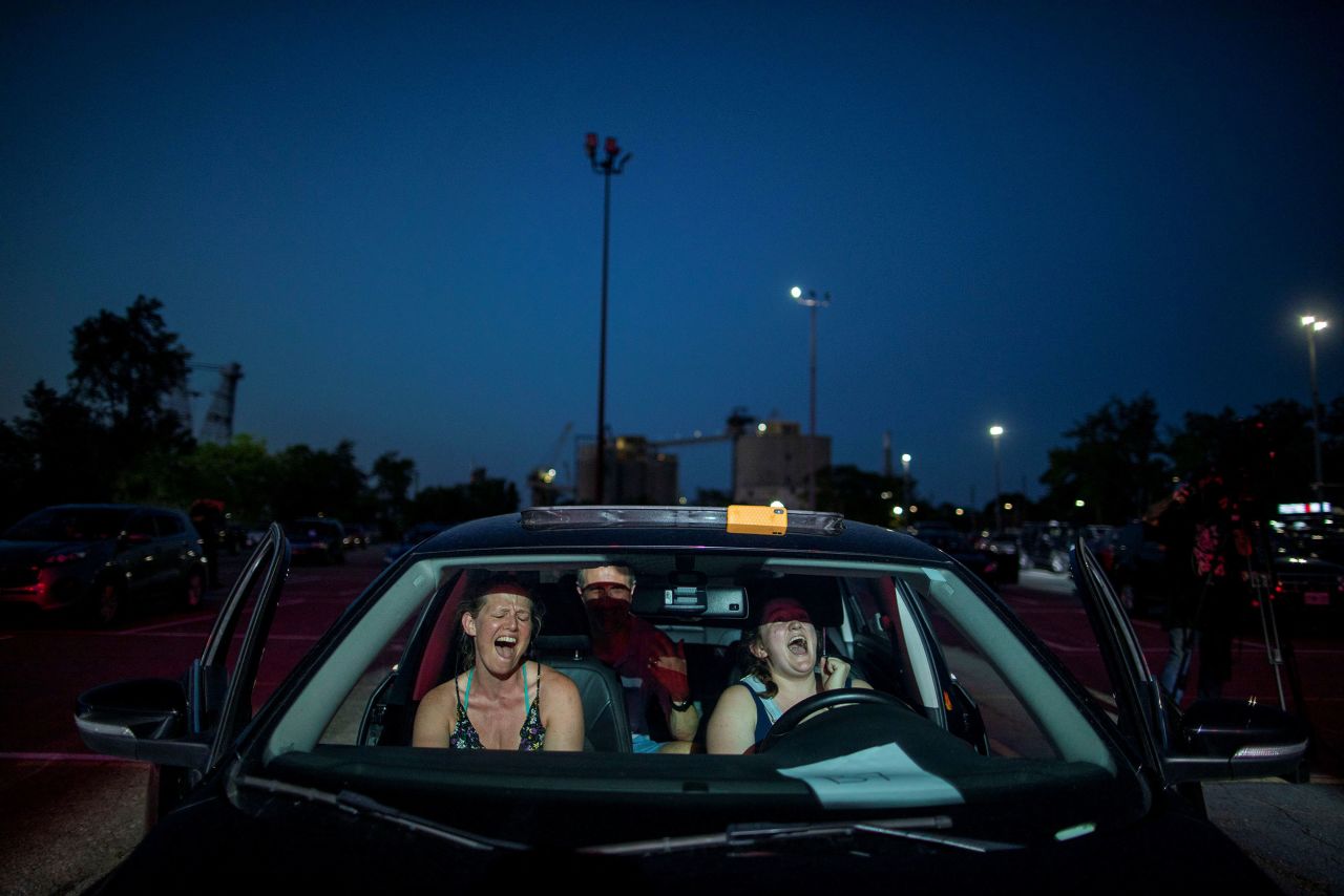 People watch a performance of the rock band Monster Truck during a drive-in concert in Toronto on July 17. <a href="http://www.cnn.com/2020/05/07/world/gallery/drive-thrus-drive-ins-coronavirus/index.html" target="_blank">Related photos: How we're relying on our cars during the pandemic</a>