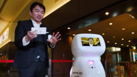 Donut Robotics CEO Taisuke Ono tests out the communication robot prototype, Cinnamon, at Tokyo's Haneda Airport in 2017.