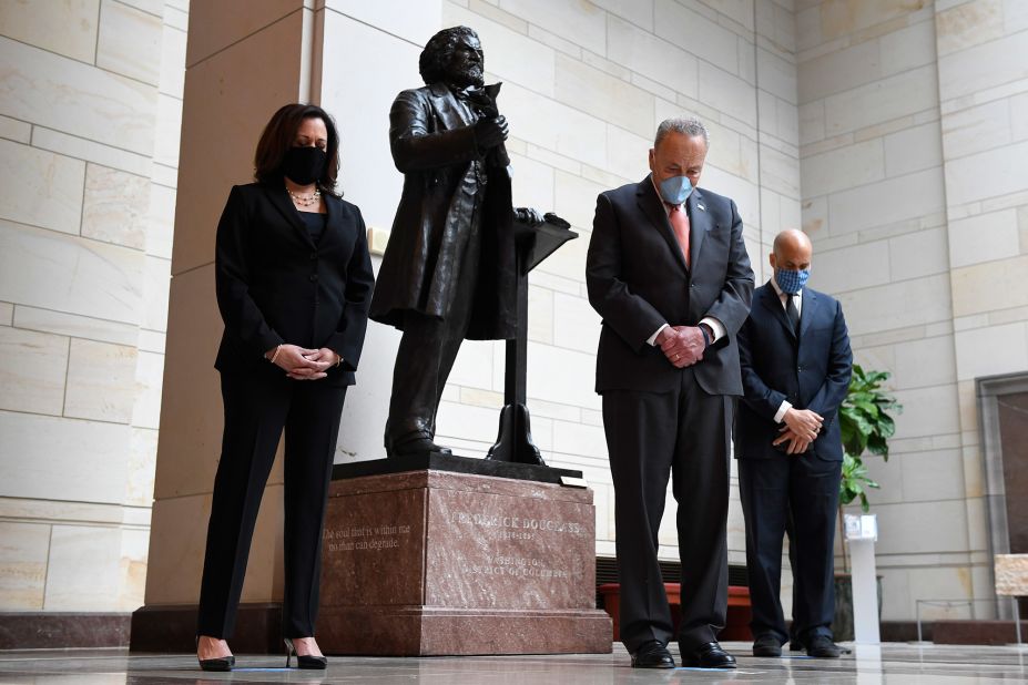 From left, Harris, Senate Minority Leader Chuck Schumer and US Sen. Cory Booker stand near a Capitol Hill statue of abolitionist Frederick Douglass during a June 2020 event commemorating the life of George Floyd. Floyd, an unarmed Black man, was killed in police custody in Minneapolis.