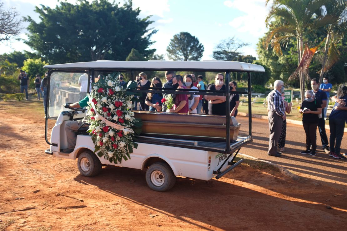 Mourners at the burial of Sgt Jonas Mendon?a, a military policeman who died with Covid-19.