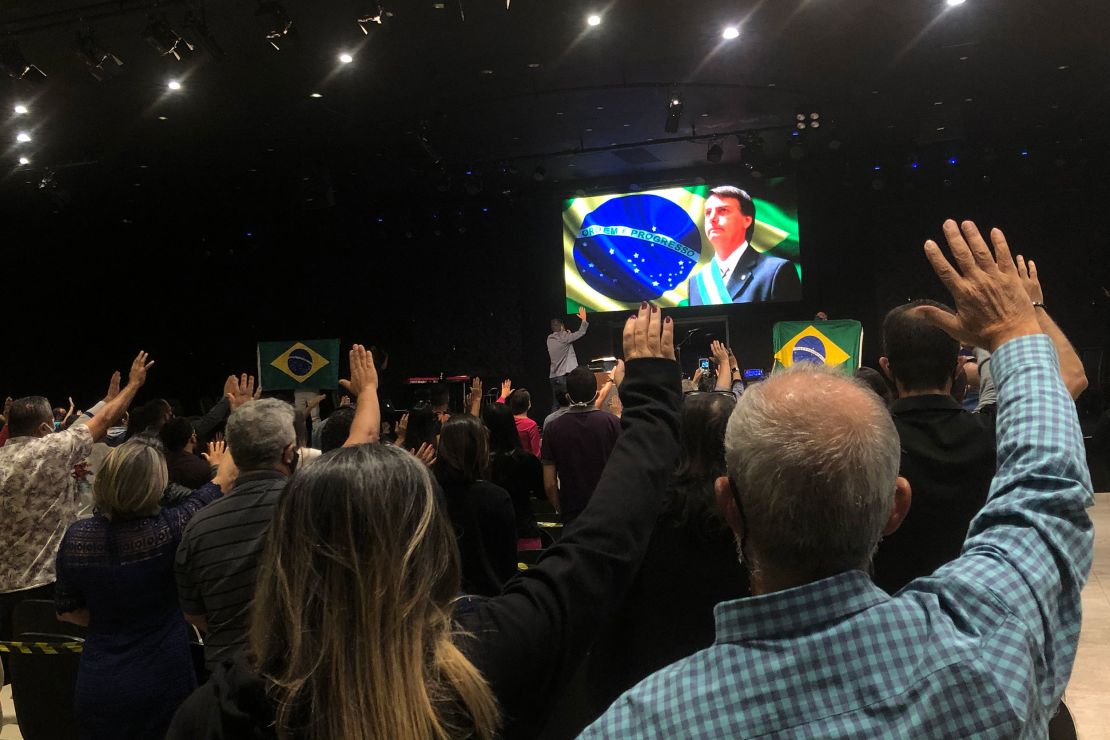 The congregation at Nucléo de Fé evangelical church prays for President Jair Bolsonaro.