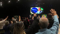 The congregation at Nucléo de Fé evangelical church prays for President Jair Bolsonaro.