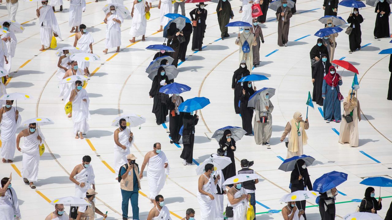 A limited numbers of pilgrims move several feet apart as they keep social distancing to limit exposure and the potential transmission of the coronavirus.
