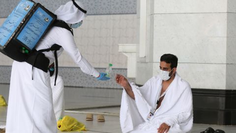A picture taken on July 29, 2020 shows a pilgrim receiving water at the Grand Mosque complex in the holy city of Mecca.
