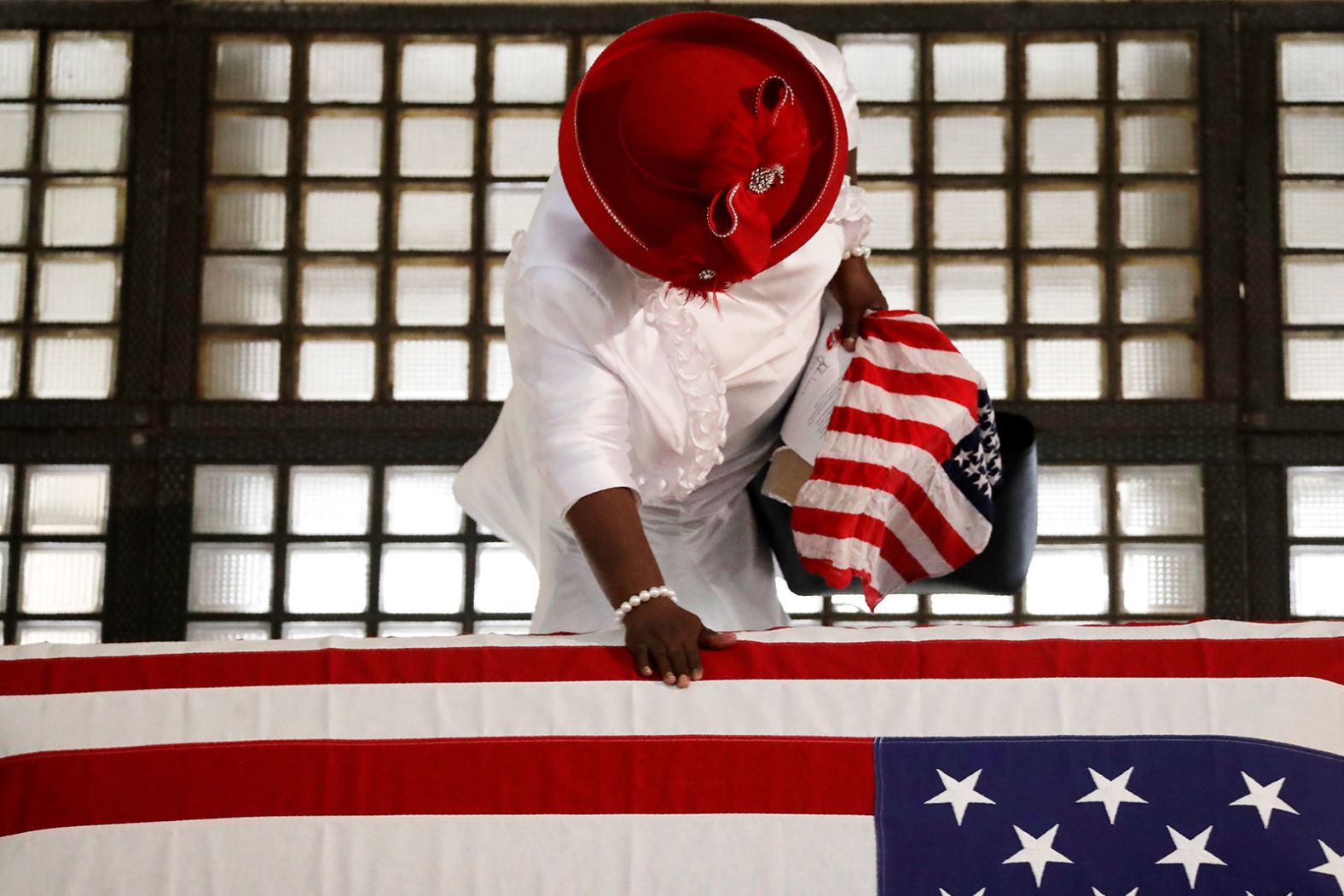 A woman pauses by Lewis' casket on Wednesday.