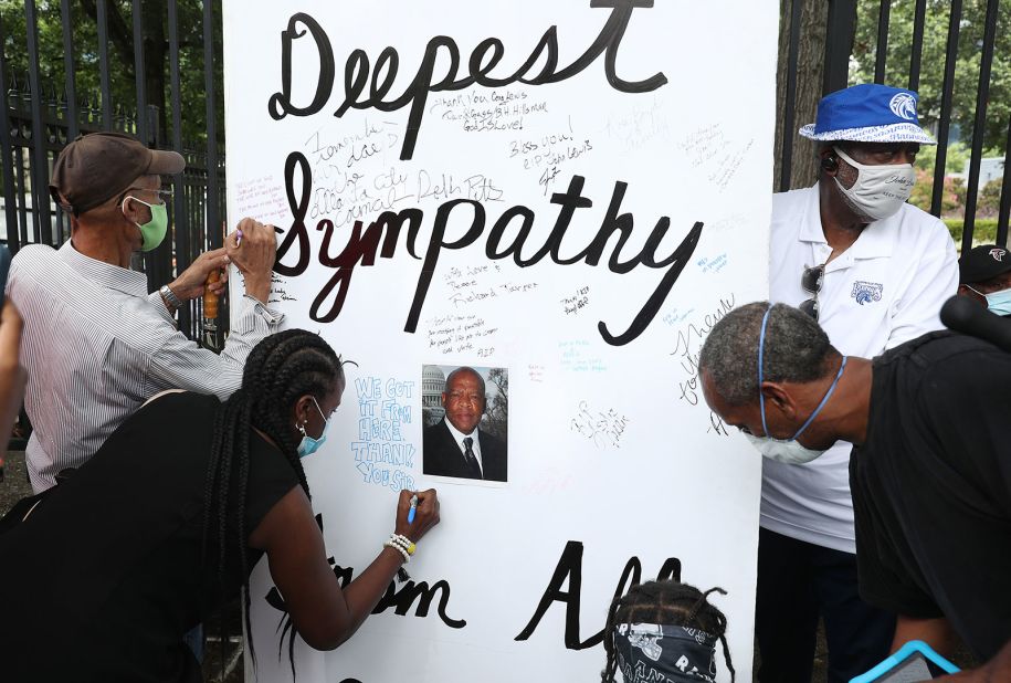 People sign a sympathy card outside the Georgia State Capitol.