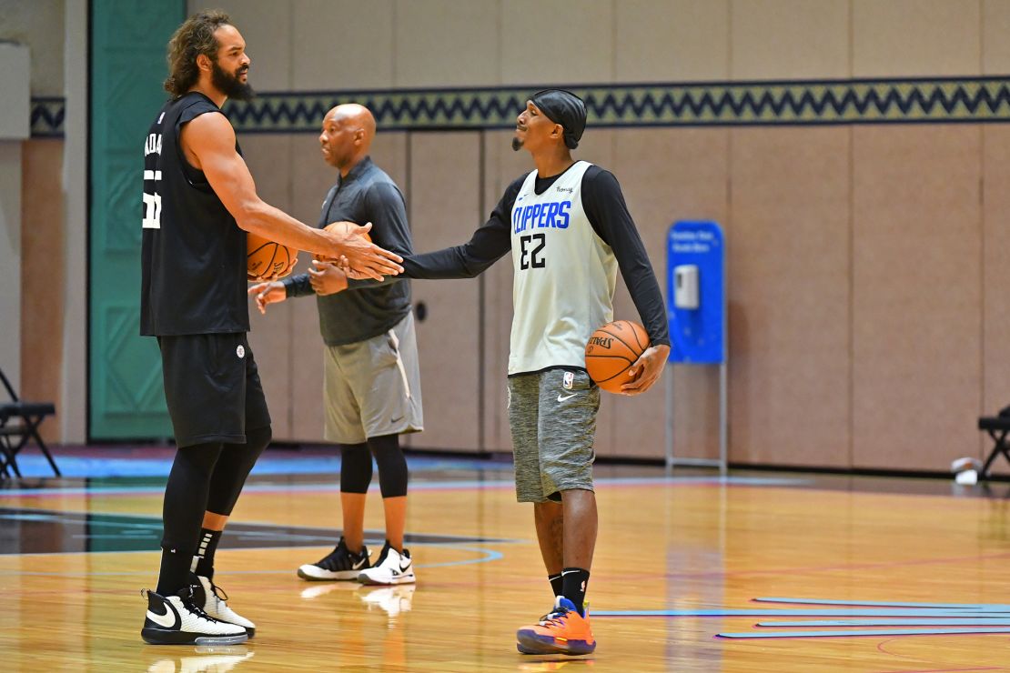 Joakim Noah #55 and Lou Williams #23 of the LA Clippers shake hands during practice as part of the NBA restart 2020 on July 21, 2020 in Orlando, Florida. 