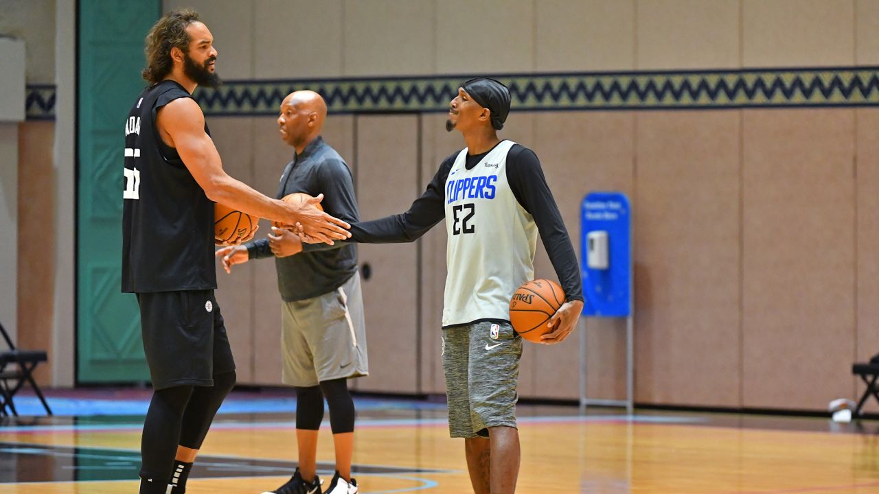 Joakim Noah #55 and Lou Williams #23 of the LA Clippers shake hands during practice as part of the NBA restart 2020 on July 21, 2020 in Orlando, Florida. 