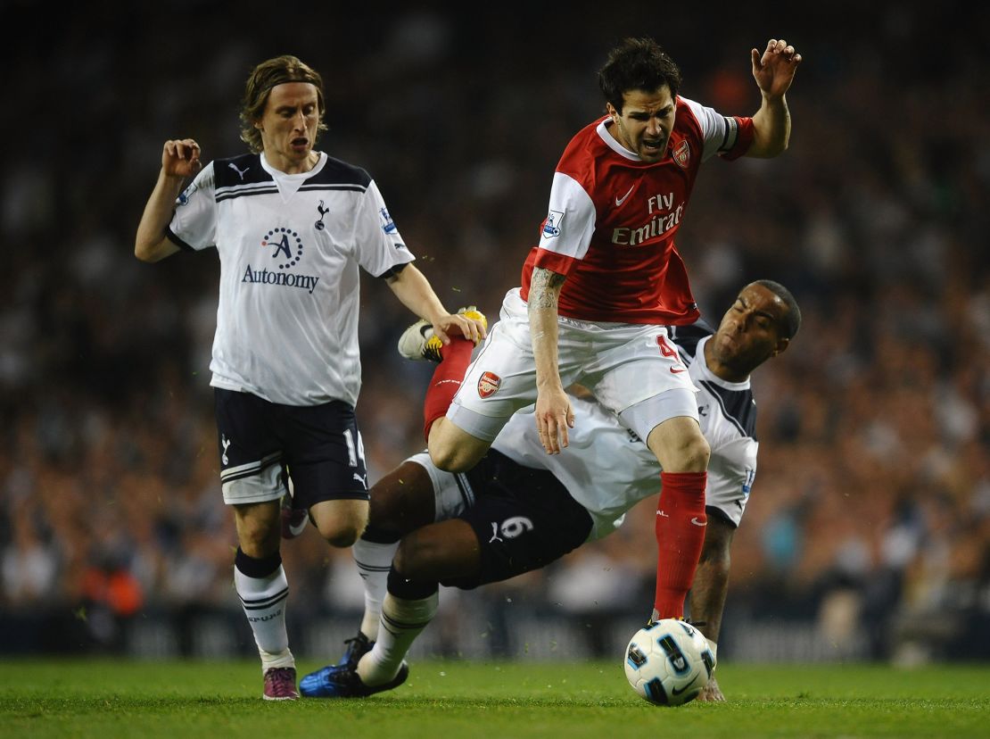 Playing for Arsenal, Fabregas is tackled by Tom Huddlestone of Spurs during the Premier League match between Tottenham Hotspur and Arsenal at White Hart Lane on April 20, 2011 in London, England.