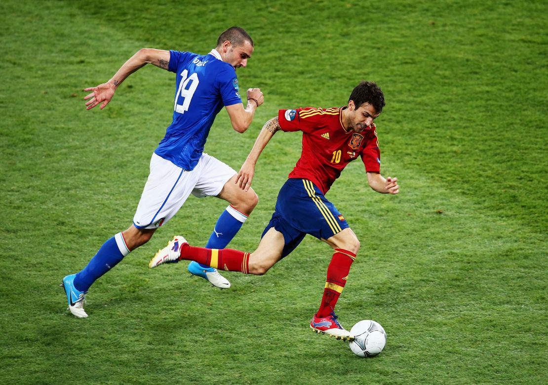 Fabregas (R) runs with the ball past Leonardo Bonucci of Italy during the UEFA EURO 2012 final match between Spain and Italy at the Olympic Stadium on July 1, 2012 in Kiev, Ukraine. 