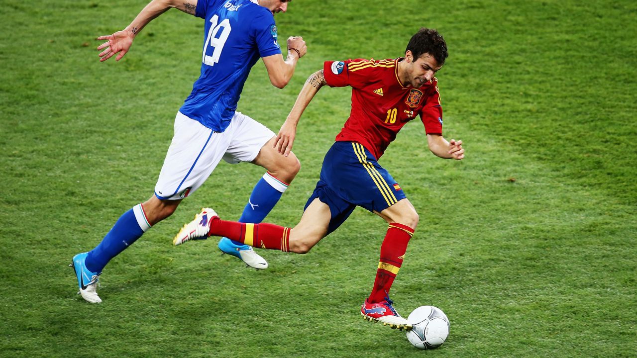 Fabregas (R) runs with the ball past Leonardo Bonucci of Italy during the UEFA EURO 2012 final match between Spain and Italy at the Olympic Stadium on July 1, 2012 in Kiev, Ukraine.