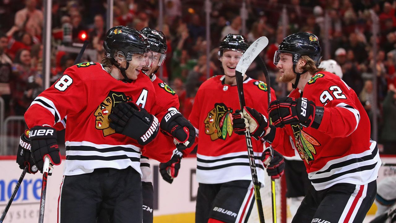 Patrick Kane of the Chicago Blackhawks (L) celebrates with (L-R) Slater Koekkoek, Olli Maatta and Alex Nylander at the United Center on March 11, 2020 in Chicago, Illinois.