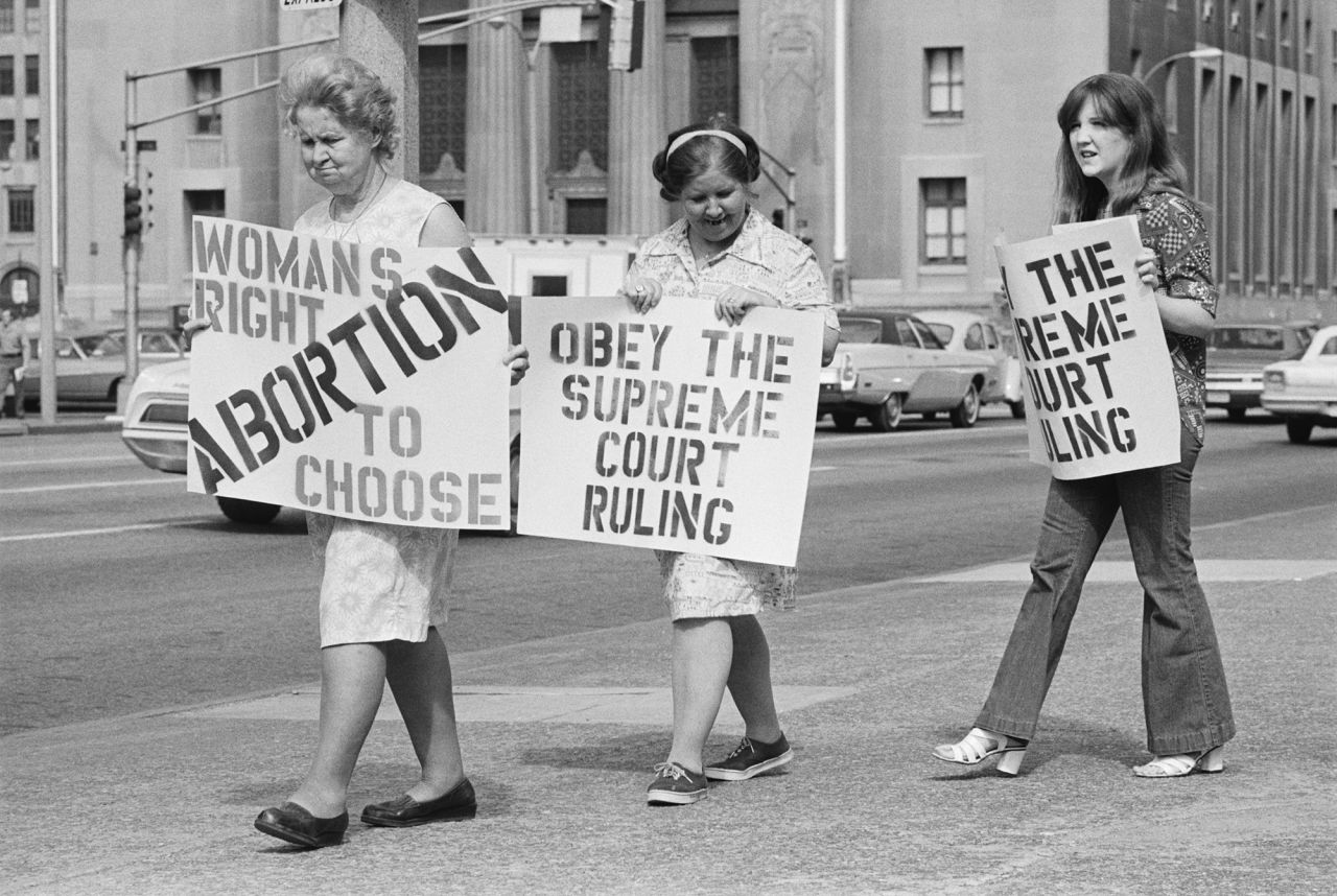 In 1973, the US Supreme Court ruled in a landmark decision, Roe v. Wade, that a woman's right to an abortion was protected by the 14th Amendment to the Constitution. Although the decision legalized abortion, states were allowed to regulate abortion in the second and third trimesters of pregnancy. Here, three generations of women join a picket line to protest St. Louis Mayor John Poelker after he refused to allow city hospitals to perform any abortions after the Supreme Court ruling. 