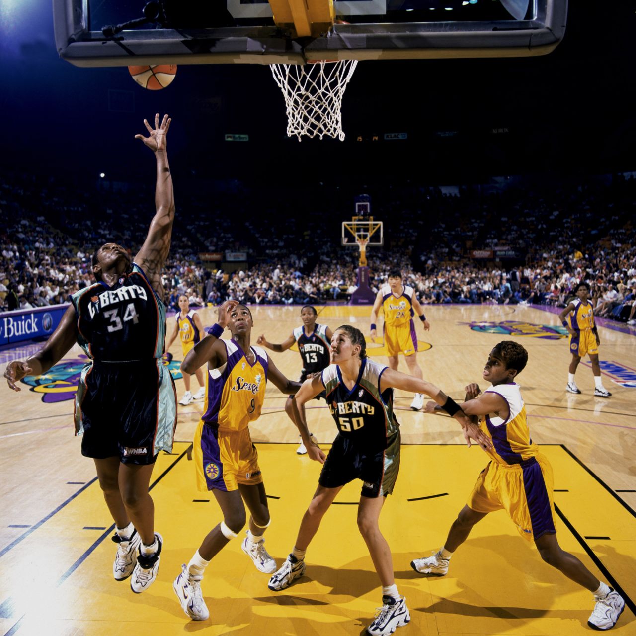 The Los Angeles Sparks face the New York Liberty during the WNBA's inaugural game in 1997. The league started with eight teams spread across the East and West coasts. In the inaugural game, Sparks guard Penny Toler scored the first basket.