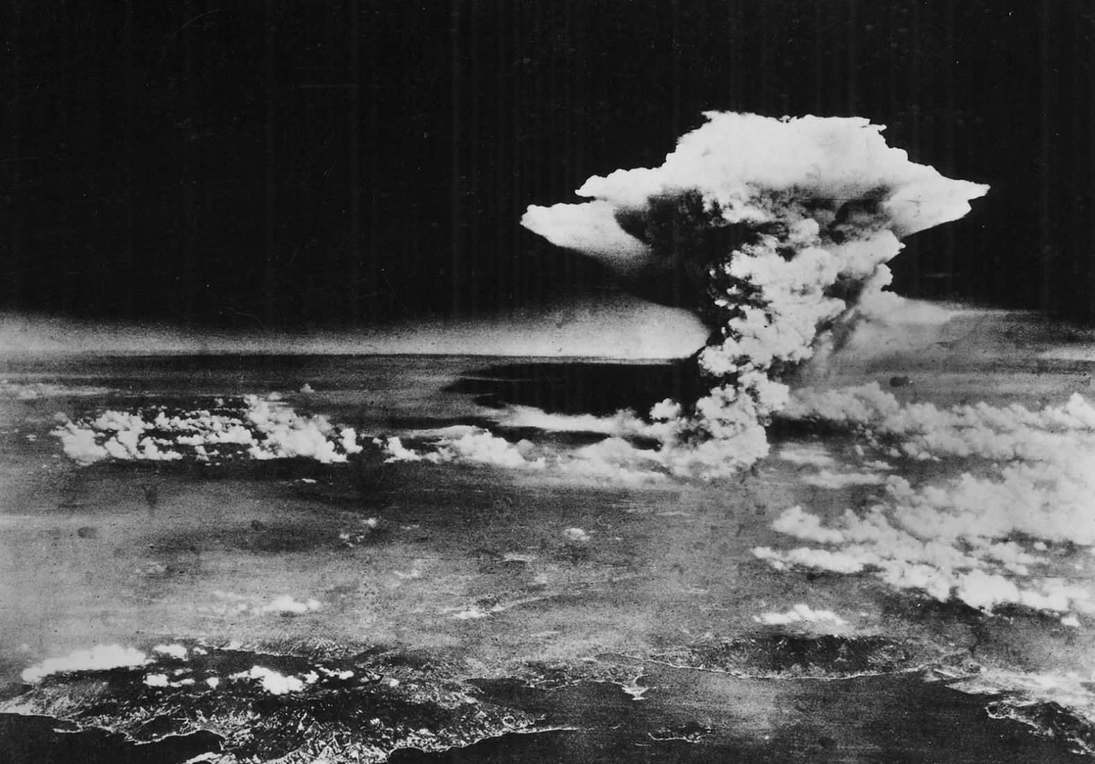 A mushroom cloud billows over Hiroshima about one hour after detonation. At least 70,000 people were killed in the initial blast, while approximately 70,000 more died from radiation exposure. "The five-year death total may have reached or even exceeded 200,000, as cancer and other long-term effects took hold," according to the Department of Energy's <a href="index.php?page=&url=https%3A%2F%2Fwww.osti.gov%2Fopennet%2Fmanhattan-project-history%2FEvents%2F1945%2Fhiroshima.htm" target="_blank" target="_blank">history of the Manhattan Project.</a>